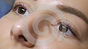 The face of a young girl before a modern eyelash lamination procedure in a professional beauty salon before the eyelash