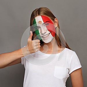 Young woman with Mexica flag painted on her face photo