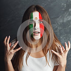 Young woman with Mexica flag painted on her face photo