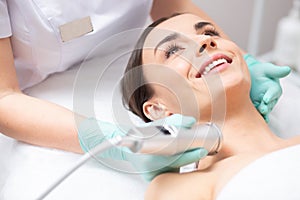 Close up of the face of happy lady during oxygen meso therapy photo