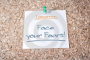 Face Your Fears Reminder For Tomorrow On Paper Pinned On Cork Board