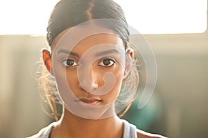 Face your fitness goals dead in the eye. Portrait of a fit young woman working out in a gym.