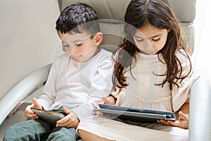 Faceless children with tablet computer and mobile phone. Kids study online. Little girl with laptop pc and boy with cell