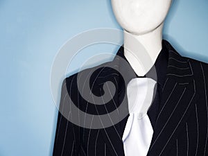 Faceless dummy model dressed in business suit and tie