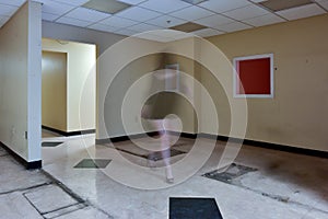 Faceless female walking through empty office space