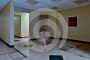 Faceless female walking through empty office space