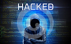 Faceless hacker on code background