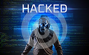 Faceless hacker on code background