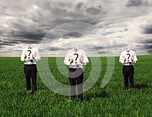 Faceless men holding placard with question mark