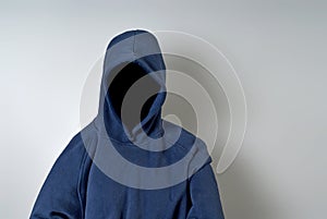 Faceless Person in Blue Hoodie