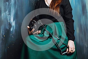 Faceless shot of a woman holding vintage film cameras in a photo studio