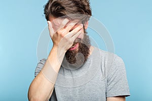 Facepalm ashamed embarrassed man covering face photo