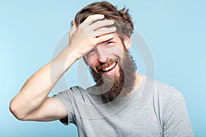 Facepalm smiling man cover face shame embarrassment