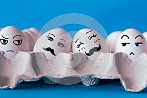 Faces on the eggs, homophobia concept, gay couple in love, social pressure and discrimination