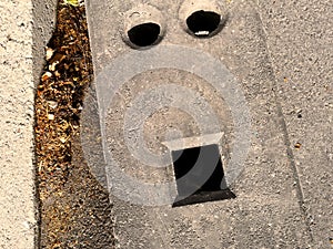 Faces In Objects - Water Runoff on A Street