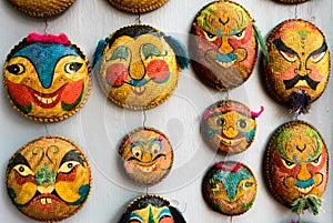 Faces painted on woven round bamboo trays in Hanoi photo