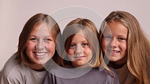 Faces of three girls in a row in casual clothes