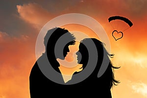 Faces of two lovers at sunset with a heart photo