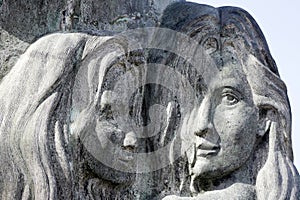 faces of two women carved in stone