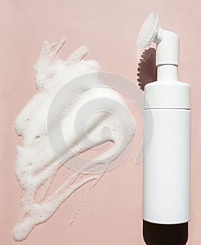 Facewash dispenser, face foam in a bottle, soap texture on natural background