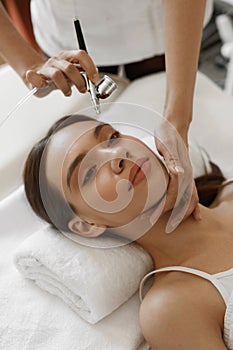 Facial Beauty Treatment. Woman Getting Oxygen Skin Peeling