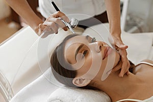 Facial Beauty Treatment. Woman Getting Oxygen Skin Peeling