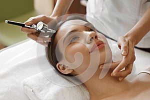 Facial Beauty Treatment. Woman Getting Oxygen Skin Peeling