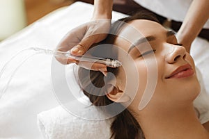 Facial Beauty Treatment. Woman Getting Oxygen Water Skin Peeling