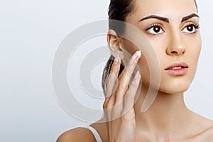 Facial Care. Female Applying Cream.Portrait Of  Young Woman With Cosmetic Cream On Skin. Closeup Of Beautiful Girl With Beauty