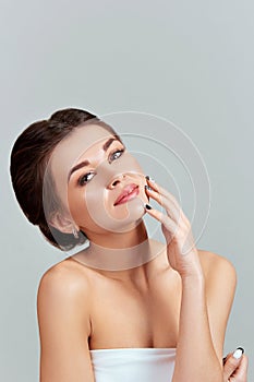 Facial Care. Female Applying Cream and Smiling. Beauty Face. Portrait Of Young Woman.