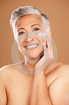 Facial, cream and mature woman, skincare lotion and sunscreen, beauty and anti aging dermatology product on studio