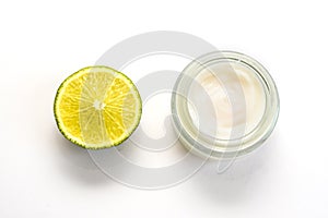 Facial cream and part of lime isolated on the white background.