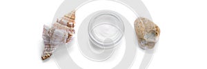 Facial cream and sea shell and stone on the isolated white background