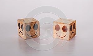 Facial on cube wooden block with emotion and expression about sincerity and frankness with metaphor on desk.