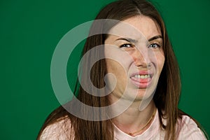 facial disgust different emotions of a young girl on a green background chromakey beautiful facial features real people