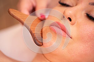 Facial madero massage of a neck and chin area