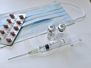 Facial Mask, Medicine, Syringe and vacine botte medical tools in time corona virus covid 19 pandemic