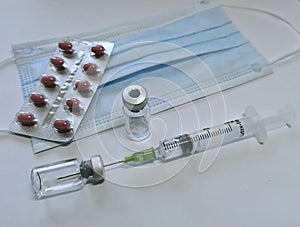 Facial Mask, Medicine, Syringe and vacine botte medical tools in time corona virus covid 19 pandemic