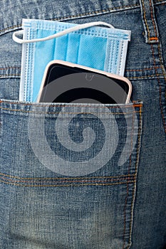 Facial mask and mobile phone in back pocket