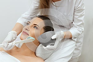Facial Mask. Woman Applying Cosmetic Alginate Mask On Skin