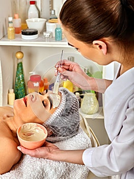 Facial massage for forty five year old woman spa salon.