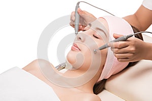 Facial massage,Peaceful brunette getting micro dermabrasion from beauty therapist photo