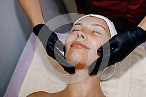 Facial massage. Spa skin and body care. Taking care of the beauty of the face. Cosmetology