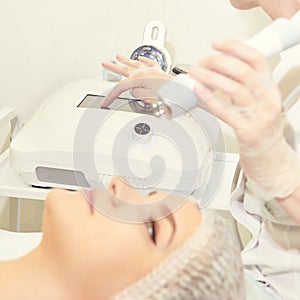 Facial micro current cosmetology procedure. Beauty technology treatment. Woman face therapy