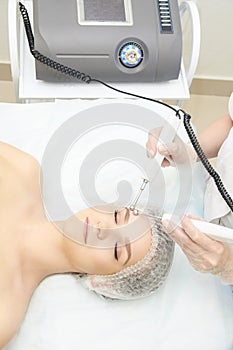 Facial micro current cosmetology procedure. Beauty technology treatment. Woman face therapy