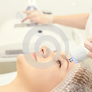 Facial micro current cosmetology procedure. Beauty technology treatment. Woman face therapy