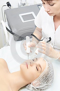 Facial micro current cosmetology procedure. Beauty technology treatment. Woman face therapy