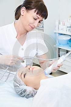 Facial micro current cosmetology procedure. Beauty technology treatment. Woman face therapy
