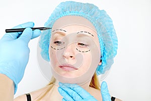 Facial plastic surgery or facelift, facelift, face correction. A plastic surgeon examines a patient before plastic surgery