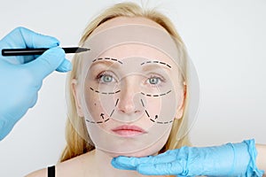 Facial plastic surgery or facelift, facelift, face correction. A plastic surgeon examines a patient before plastic surgery